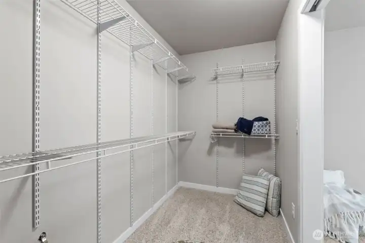 Walk-in closet off primary bedroom is large and functionally set up.