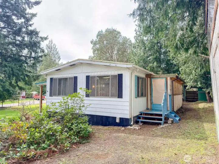 Enclosed porch along the back of the home. Open shed in the back right corner.