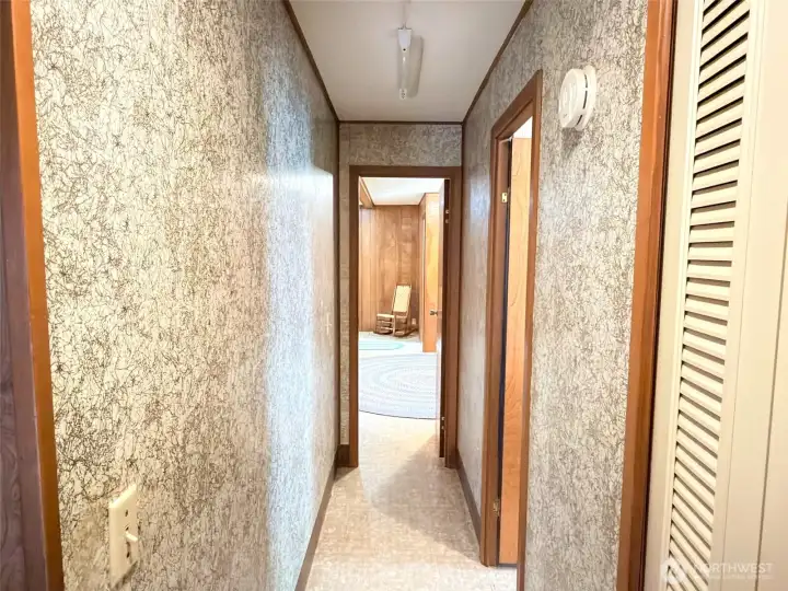 Back in the home looking toward the primary bedroom at the end of the hallway.