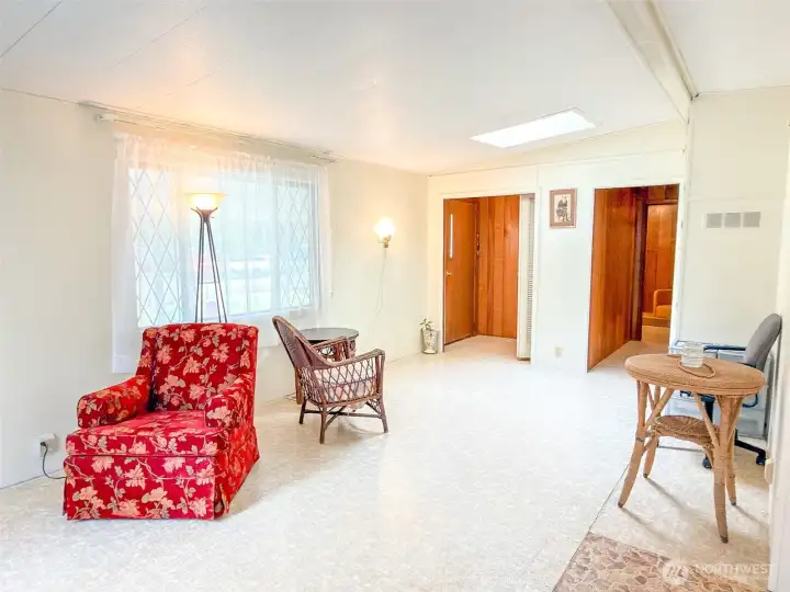 Front door & front closet on the left, and hallway to the second bedroom on the right.