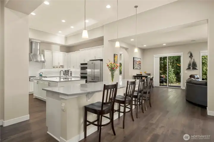 Generous spaces and gorgeous wide plank Engineered hardwood floors lead you into the heart of the home where an absolutely stunning kitchen awaits!  Gather at the large island or enjoy your morning coffee in the dining nook overlooking the lush backyard.