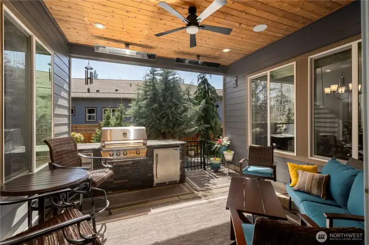 You will enjoy this courtyard space year around!  Built-in gas grill, refrigerator and drawers, Bromic heater, surround sound and stained wood ceiling. Raised concrete so you will step out to a flush patio from the oversized slider.