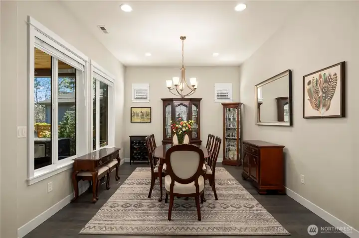 The generous dining room. Notice the beautiful Engineered hardwood, upgraded trim work and custom window treatments.
