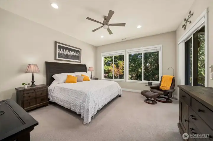 The spacious primary suit enjoys glorious views over the backyard and into the permanent greenspace. An oversized sliding glass door leads to the rear covered patio area and custom fireplace. Plush carpet & pad, ceiling fan, beautiful window wraps and cordless blinds.
