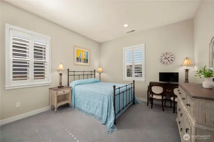 The second bedroom en suite enjoys its' own private full bath and Plantation shutters.