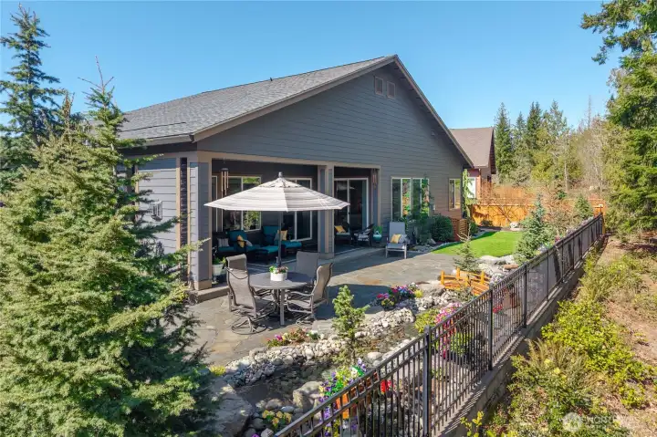 This easy-care backyard offers a serene water feature and stream, expansive Flagstone, high-grade turf and a plethora of privacy!