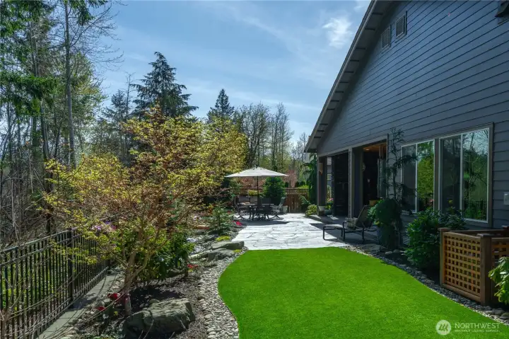 The spacious and fully fenced backyard also offers high-end turf, no mowing!