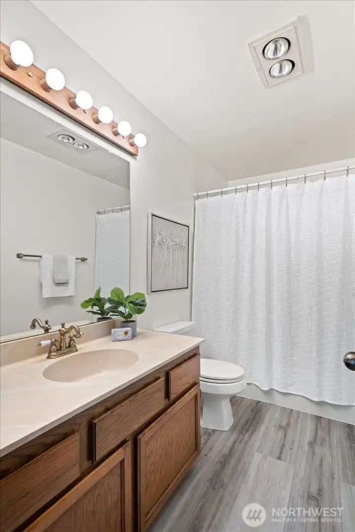 The hallway bathroom is nicely sized and perfect for guests.