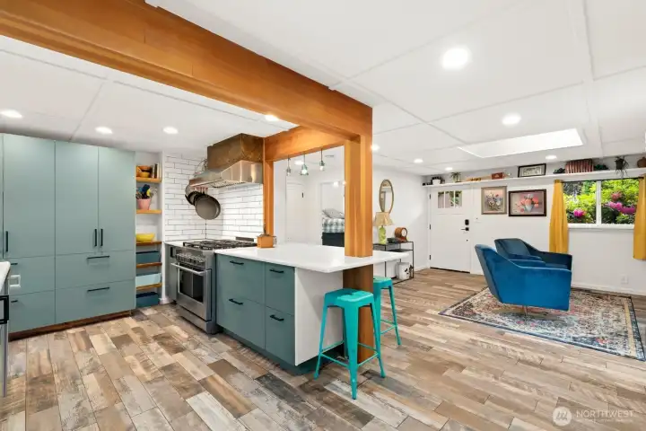 Striking architectural interest with beams highlighting the kitchen. Teal cabinets and gas appliances make this a great working kitchen.  Owner worked as a professional cook and set this kitchen up for real work!