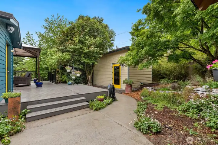 The backyard is like a dream with amazing decks and hardscaping as well as outbuildings for fun and storage.  The building in this picture is used as an (amazing) home gym!