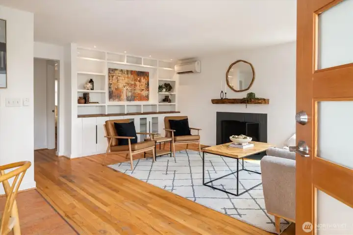 -The living room is the heart of the home, featuring a wood fireplace, built in bookshelves and gleaming hardwoods.  Almost every room in the home features a mini-split for A/C and heat.