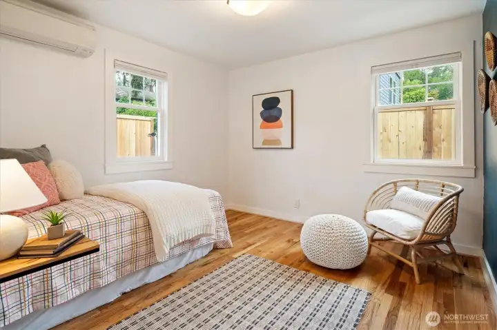 Relax in the comfort of the second of two main floor bedrooms, which features a deceptively large -closet, hardwood floors and Mini-split for A/C and heat.