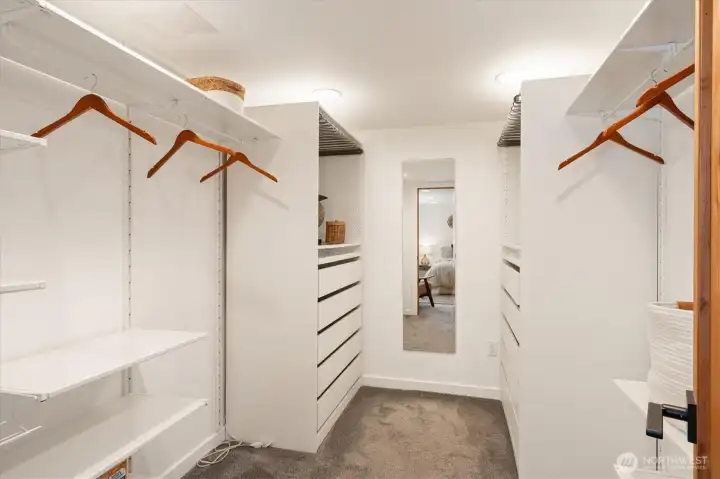 The downstairs bedroom features a huge walk in closet with built in shelving and dressers.
