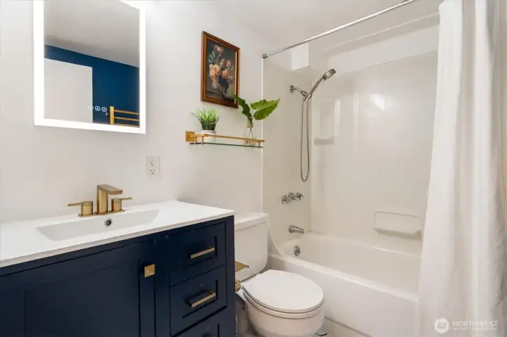 Another full bath downstairs guarantees convenience for guests and downstairs movies.