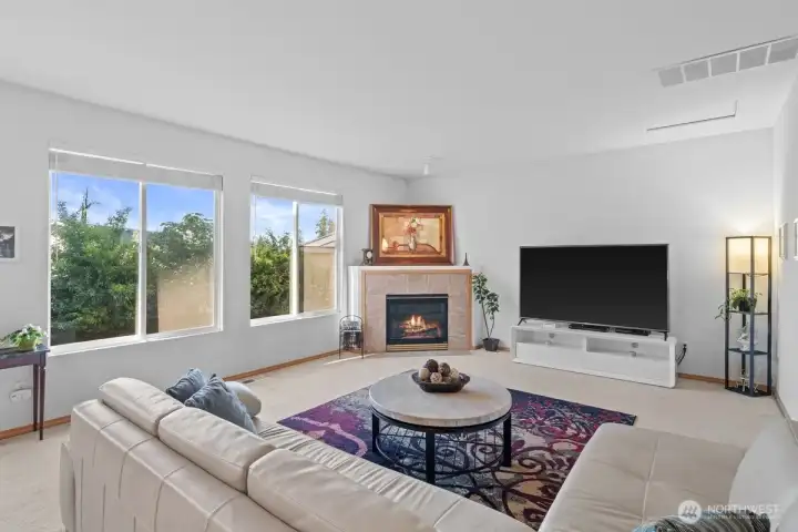 Large bright family room with corner gas fireplace. Large bright family room with corner gas fireplace.
