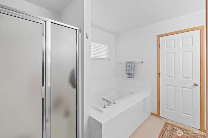 Primary bathroom with separate shower and tub. Primary bathroom with separate shower and tub.