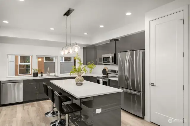 Kitchen features a pantry and a West Elm light fixture.