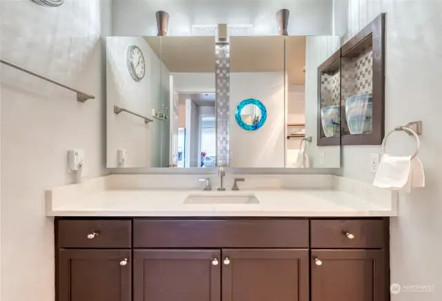 The updated full bathroom with granite countertops is easily accessible from the primary bedroom and also right off the entrance hallway.