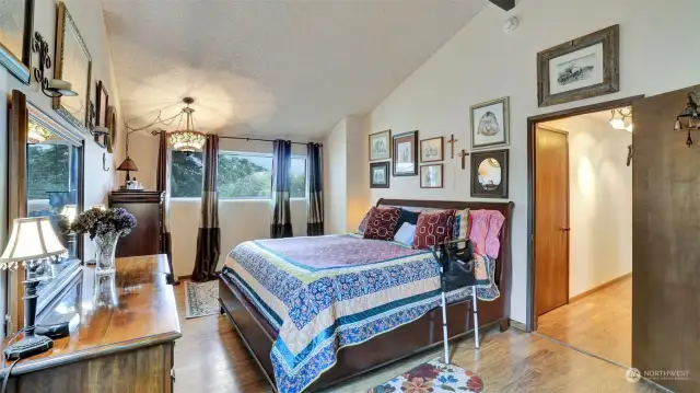 Dramatic vaulted ceilings in the primary bedroom.