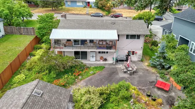 Arial view of back of home. Enjoy the beautiful yard, truly a gardener’s dream featuring a variety of flowers, plants, berries bushes and more.