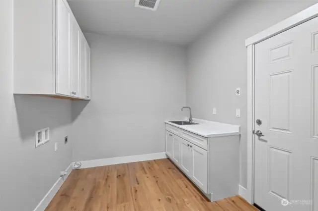 Functionality at its finest—this spacious laundry room is equipped to handle all your household needs with ease.