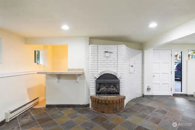 Fireplace in family room, with counter abutting the wet bar