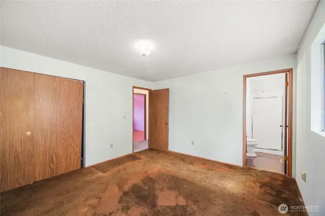 Primary bedroom showing closest and 3/4 bath.