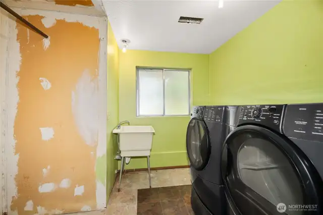 Laundry room is plumbed for toilet and awaits your remodel.