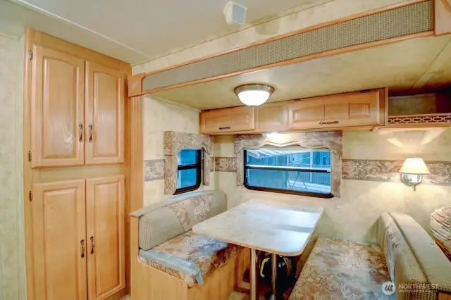 Cabinet storage and dining area that converts to another bed.