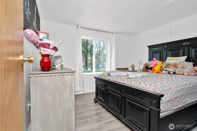 Bedroom 3 is light and bright, with soft laminate flooring that really makes the space shine—this room truly pops with warmth and charm.