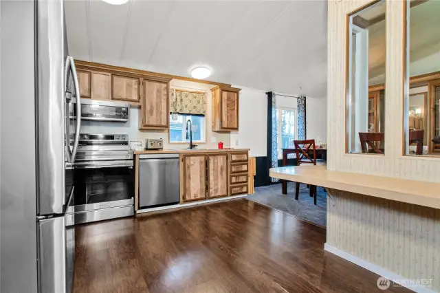 The kitchen offers a lovely view, warm laminate flooring, and a cozy eating nook—just right for enjoying a quick bite or a morning cup of coffee.
