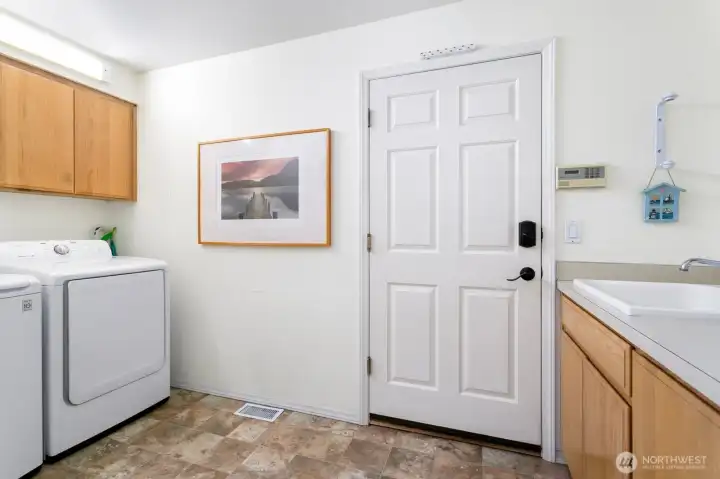 Mud room/Laundry room with utility sink allows for additional extra storage as well. Access to the garage from this drop zone.