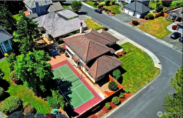 Amazing Pickle Ball Court compliments the large corner lot and traditional open floor home.