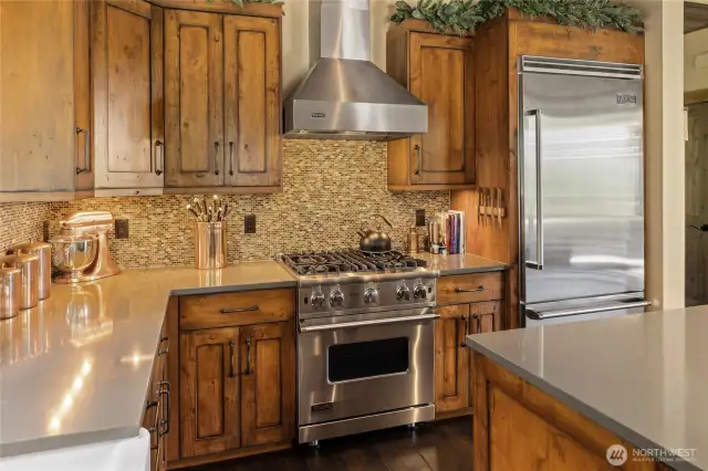 The kitchen is outfitted with a full suite of Viking Professional Series stainless steel appliances, bringing commercial-grade performance and style to the heart of the home.