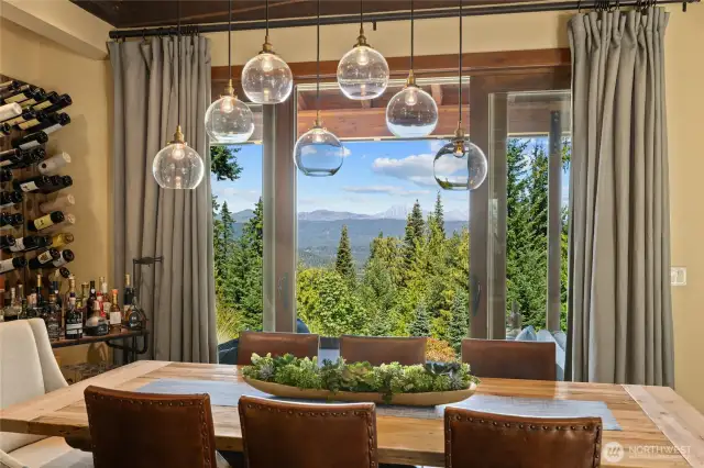 The dining room flows to a covered patio, enhanced by a custom built-in wine rack for convenient outdoor entertaining.