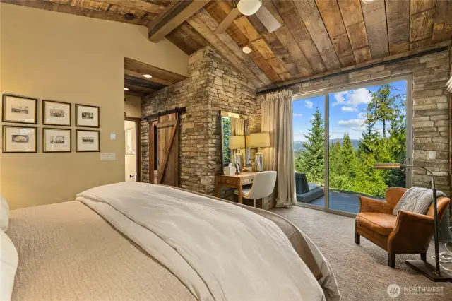 "A barn door provides access to the primary bath, while double sliding doors open to a secluded patio.