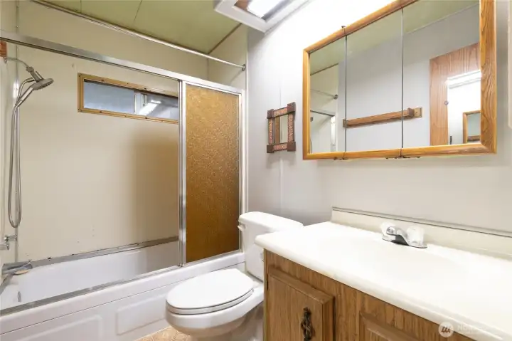 Main Full Bathroom. Nice sized vanity and tub area....just needs a bit of updating.