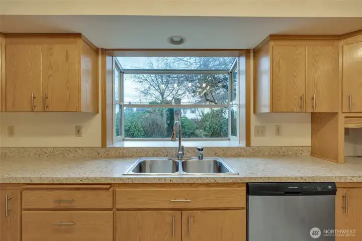 A lovely herb garden window sits above the sink for your favorite plantings.