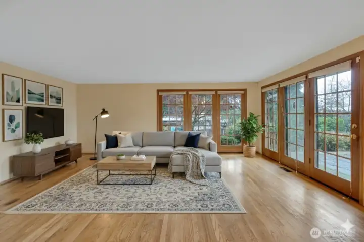 The family room showcases beautiful floor to ceiling windows.