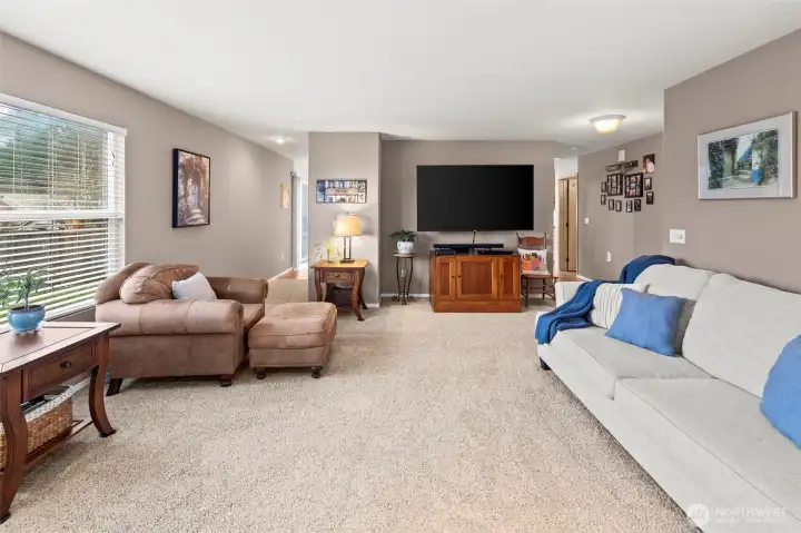 A central staircase and circular pattern create great flow through the lower level. The powder bathroom can be found in the hallway between the living room and the kitchen and dining room.
