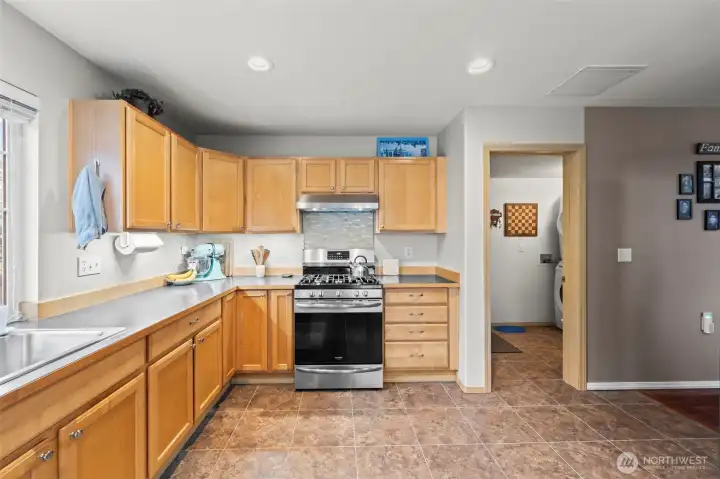The open door leads to the laundry room and then to the garage. The stacking washer and dryer are negotiable.