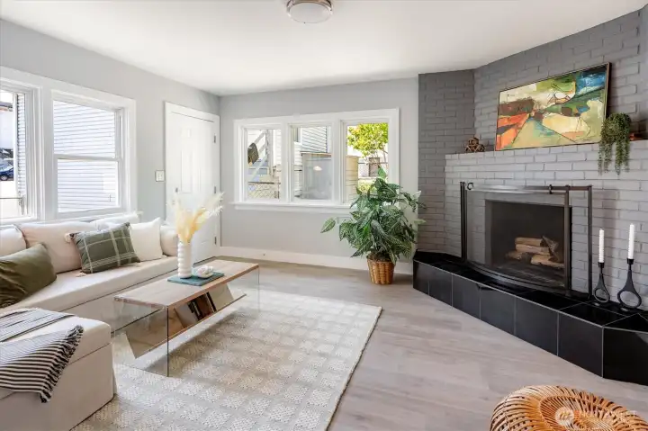 Private family room anchored by a classic fireplace effortlessly connects kitchen to courtyard. Photos from earlier listing in 2025.