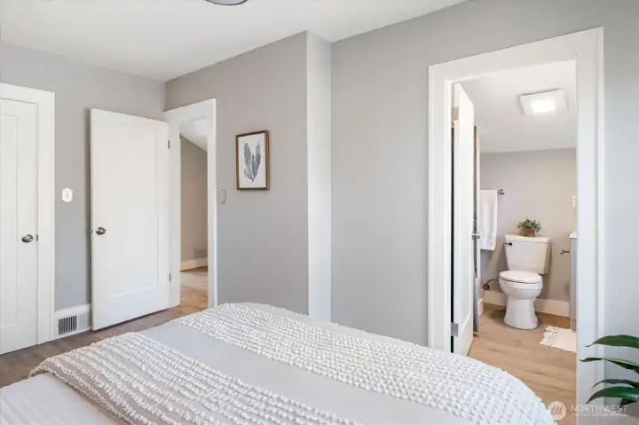 Primary bedroom offers calm and ease with an ensuite bath, walk-in, and discreet storage. Photos from earlier listing in 2025.