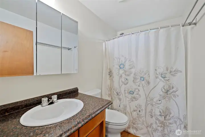 Full bathroom with shower/tub combo.