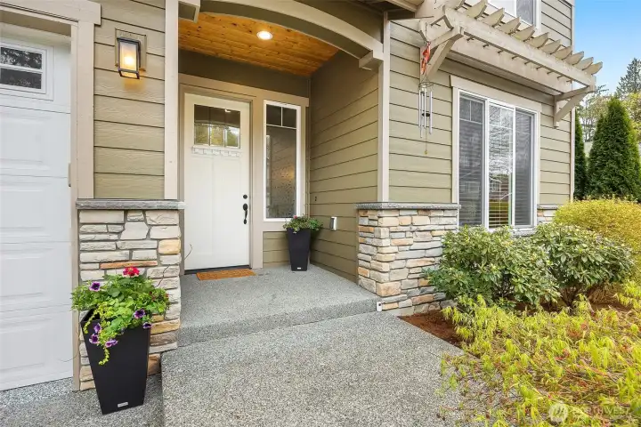 Welcoming entryway with beautiful landscaping.