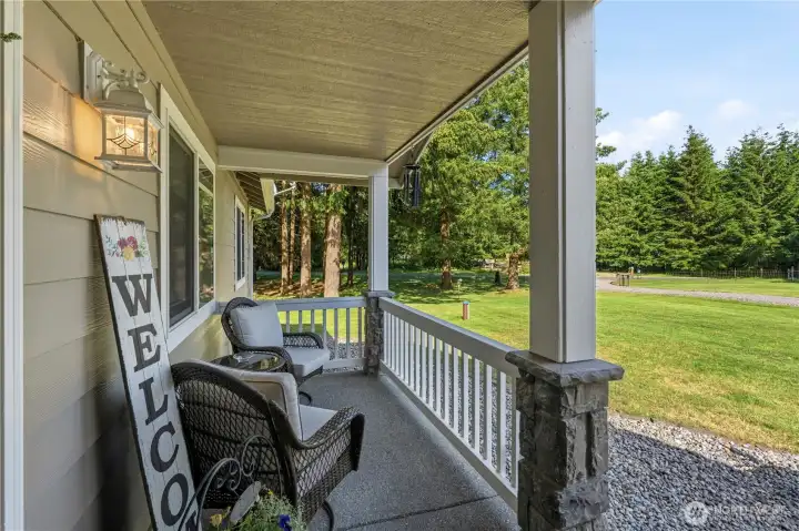 Relax on the covered front porch and enjoy the peaceful scenery