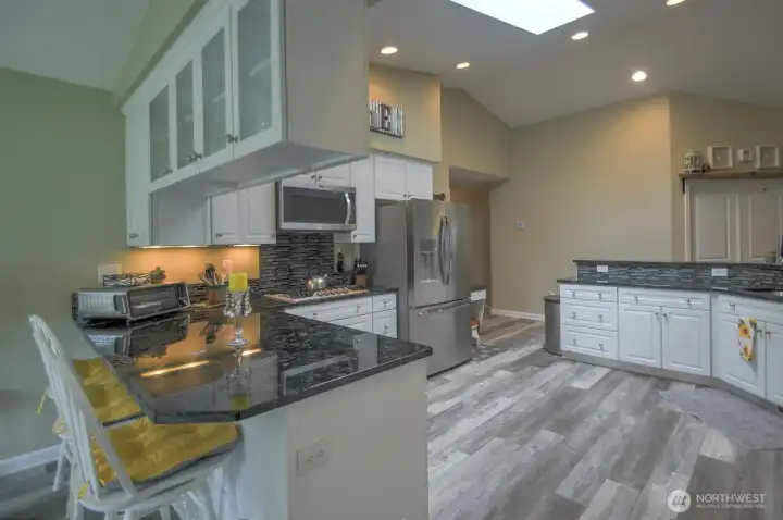 Updated granite counter tops and additional kitchen seating