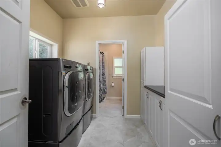 Laundry and storage area, with full bathroom through the doorway.