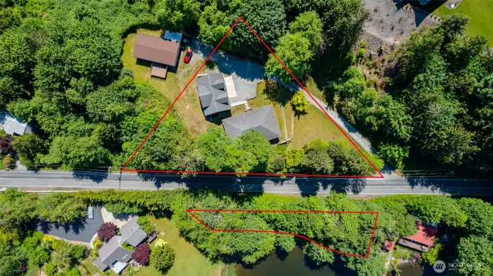 Red lines illustrate approximate boundaries of both the main parcel (with home and shop), and the undivided 1/6 interest waterfront parcel.