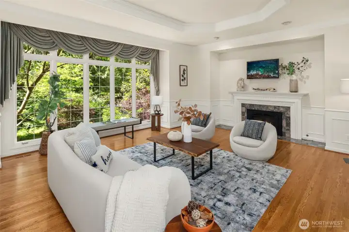 Inviting living room overlooks creek + backyard
